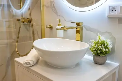 a bathroom with a bowl sink and a shower at DS Apartamenty Jaśminowa in Zator