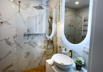 a bathroom with a sink and a shower at DS Apartamenty Jaśminowa in Zator