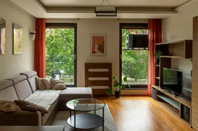 a living room with a couch and a tv at Kraków Główny Apartment - Parking, Workspace - by Rentujemy in Kraków