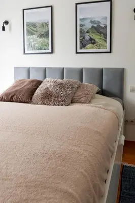 a bed in a bedroom with two pictures on the wall at Kraków Główny Apartment - Parking, Workspace - by Rentujemy in Kraków