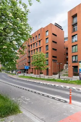 an empty street in front of a brick building at Kraków Główny Apartment - Parking, Workspace - by Rentujemy in Kraków