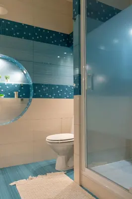 a bathroom with a toilet and a glass shower at Kraków Główny Apartment - Parking, Workspace - by Rentujemy in Kraków