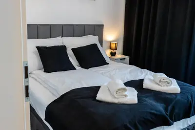 a bedroom with two towels on a bed at DS Apartamenty Jaśminowa in Zator