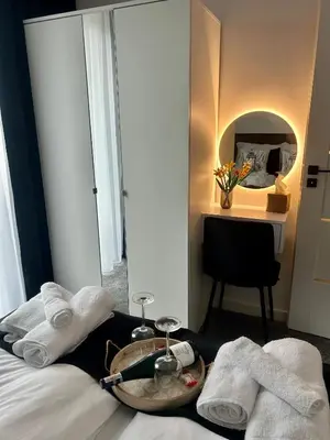 a hotel room with a tray of towels and a table at DS Apartamenty Jaśminowa in Zator