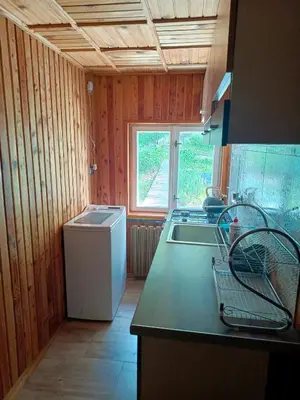 a kitchen with a sink and a washing machine at Noclegi u Ewusi 2 in Januszowice