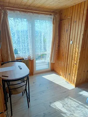 a room with a table and a large window at Noclegi u Ewusi 2 in Januszowice