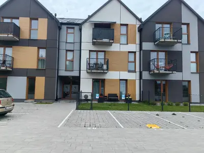 an apartment building with balconies and a parking lot at Apartamenty Zator Jaśminowa in Zator