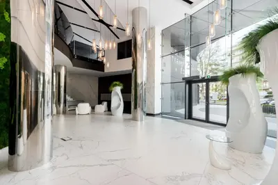 a lobby of a building with white vases on the floor at Wiślane Tarasy 2 0 Chic Studio by BookingHost in Kraków