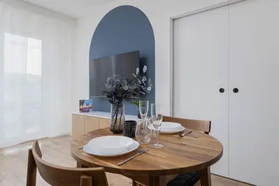 a dining room with a wooden table and chairs at Modern Apartment in Kraków Podgórze by Noclegi Renters in Kraków