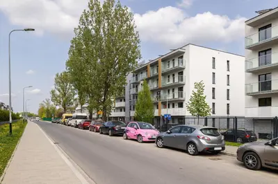 a row of cars parked on the side of a street at Modern Apartment in Kraków Podgórze by Noclegi Renters in Kraków