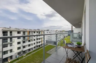 an apartment balcony with a view of buildings at Modern Apartment in Kraków Podgórze by Noclegi Renters in Kraków