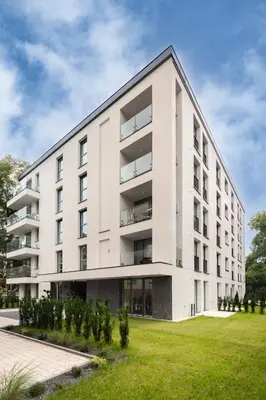 an apartment building with a green lawn at Metropolis Old Town Apartments in Kraków