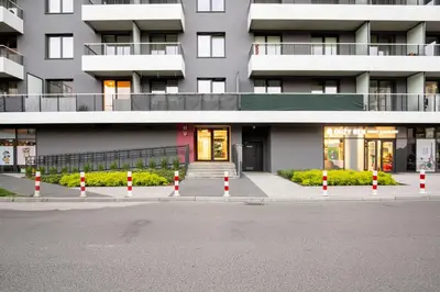 an empty street in front of a building at Bronowice Comfy Studio by BookingHost in Kraków