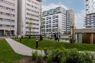 a park in a city with tall buildings at Bronowice Comfy Studio by BookingHost in Kraków