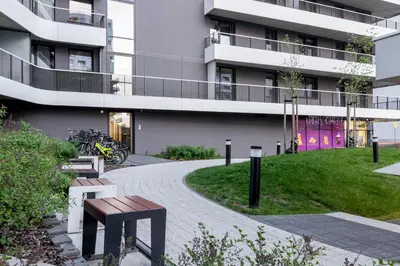 a building with purple doors and a walkway at Bronowice Comfy Studio by BookingHost in Kraków