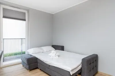 a bedroom with a bed and a window at Bronowice Comfy Studio by BookingHost in Kraków