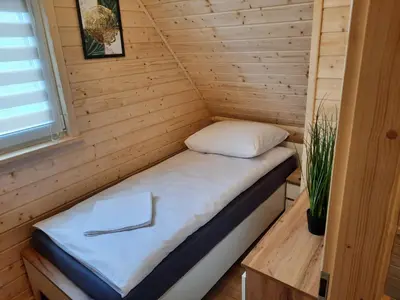 a bed in a tiny house at Energy4YOU Zator in Zator