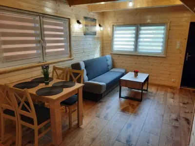 a living room with a couch and a table at Energy4YOU Zator in Zator