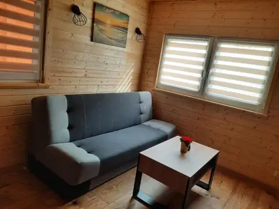 a living room with a blue couch and a table at Energy4YOU Zator in Zator