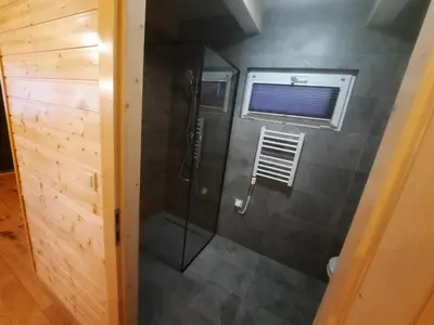a bathroom with a shower with a glass door at Energy4YOU Zator in Zator