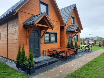 a house with a table and benches on it at Energy4YOU Zator in Zator