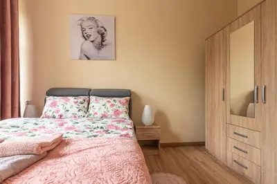 a bedroom with a bed with a drawing on the wall at Apartament 45m2 - Sunny&Quiet - VERY CLOSE to Auschwitz Museum ! in Oświęcim