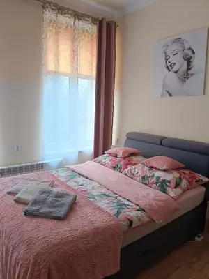 a bedroom with a bed with a blanket and a window at Apartament 45m2 - Sunny&Quiet - VERY CLOSE to Auschwitz Museum ! in Oświęcim