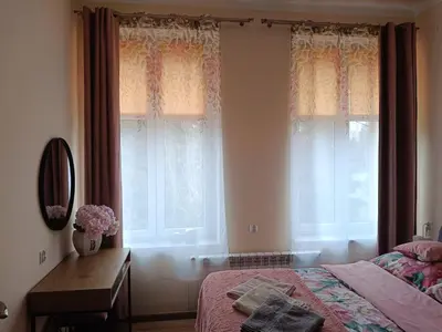 a bedroom with a bed and a desk and windows at Apartament 45m2 - Sunny&Quiet - VERY CLOSE to Auschwitz Museum ! in Oświęcim