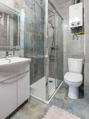 a bathroom with a shower and a toilet and a sink at Apartament 45m2 - Sunny&Quiet - VERY CLOSE to Auschwitz Museum ! in Oświęcim
