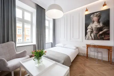 a living room with a bed and a painting on the wall at Native Apartments Starowiślna 43 in Kraków