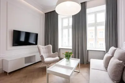 a living room with a couch and a tv at Native Apartments Starowiślna 43 in Kraków