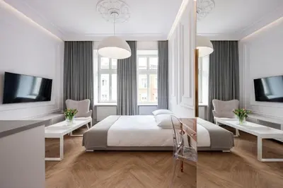 a white bedroom with a bed and two windows at Native Apartments Starowiślna 43 in Kraków