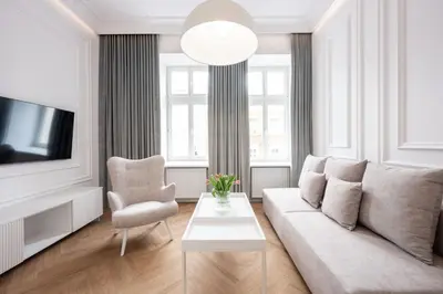 a living room with a couch and a tv and a chair at Native Apartments Starowiślna 43 in Kraków
