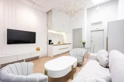 a living room with white furniture and a flat screen tv at Native Apartments Starowiślna 43/15 in Kraków