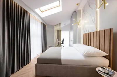 a bedroom with a bed and a large window at Native Apartments Starowiślna 43/15 in Kraków