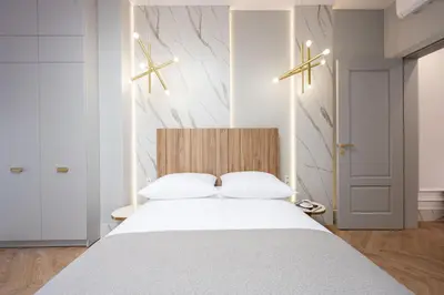 a bedroom with a large white bed with white sheets at Native Apartments Starowiślna 43/15 in Kraków