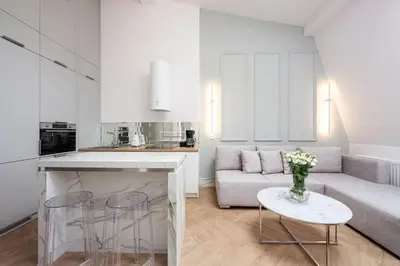 a room with white walls and a white tile floor at Native Apartments Starowiślna 43/16 in Kraków