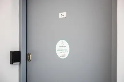 a door with a sign on it in a room at Native Apartments Starowiślna 43/16 in Kraków