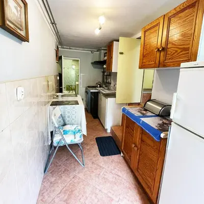 a small kitchen with a table and a refrigerator at Źródlana13 Apartamenty Maków Podhalański in Maków Podhalański