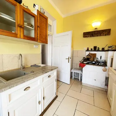 a kitchen with yellow walls and white cabinets and a sink at Źródlana13 Apartamenty Maków Podhalański in Maków Podhalański