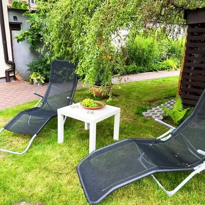 two chairs and a table in the grass at Źródlana13 Apartamenty Maków Podhalański in Maków Podhalański