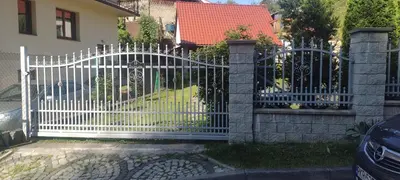 a white gate in front of a house at Źródlana13 Apartamenty Maków Podhalański in Maków Podhalański