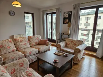 a living room with couches and a coffee table at Bulwary Wiślane Kraków Apartament Ludwinowska przy Forum by Noclegi Renters in Kraków