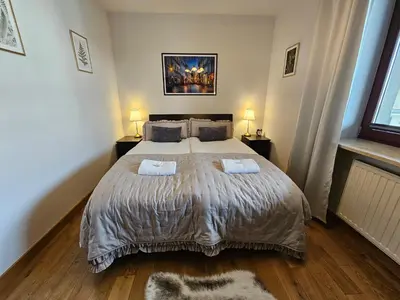 a bedroom with a large bed with two pillows at Bulwary Wiślane Kraków Apartament Ludwinowska przy Forum by Noclegi Renters in Kraków
