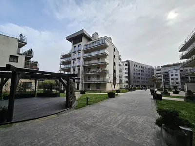 an empty street in a city with tall buildings at Bulwary Wiślane Kraków Apartament Ludwinowska przy Forum by Noclegi Renters in Kraków
