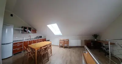 a kitchen with a wooden table and a kitchen with a ceiling at Pokoje Izabela - Noclegi Graboszyce - Zator in Graboszyce