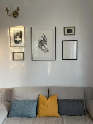 a living room with a couch and pictures on the wall at Greenthumb Praska in Kraków