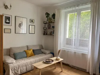 a living room with a couch and a table at Greenthumb Praska in Kraków