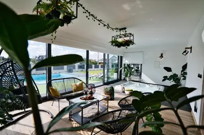 a living room with a pool and some plants at Dom z jacuzzi do 10 osób Zator Willa LuxHouse in Zator