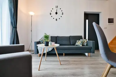 a living room with a blue couch and a table at Domki na Sosnowej by Housine in Zator